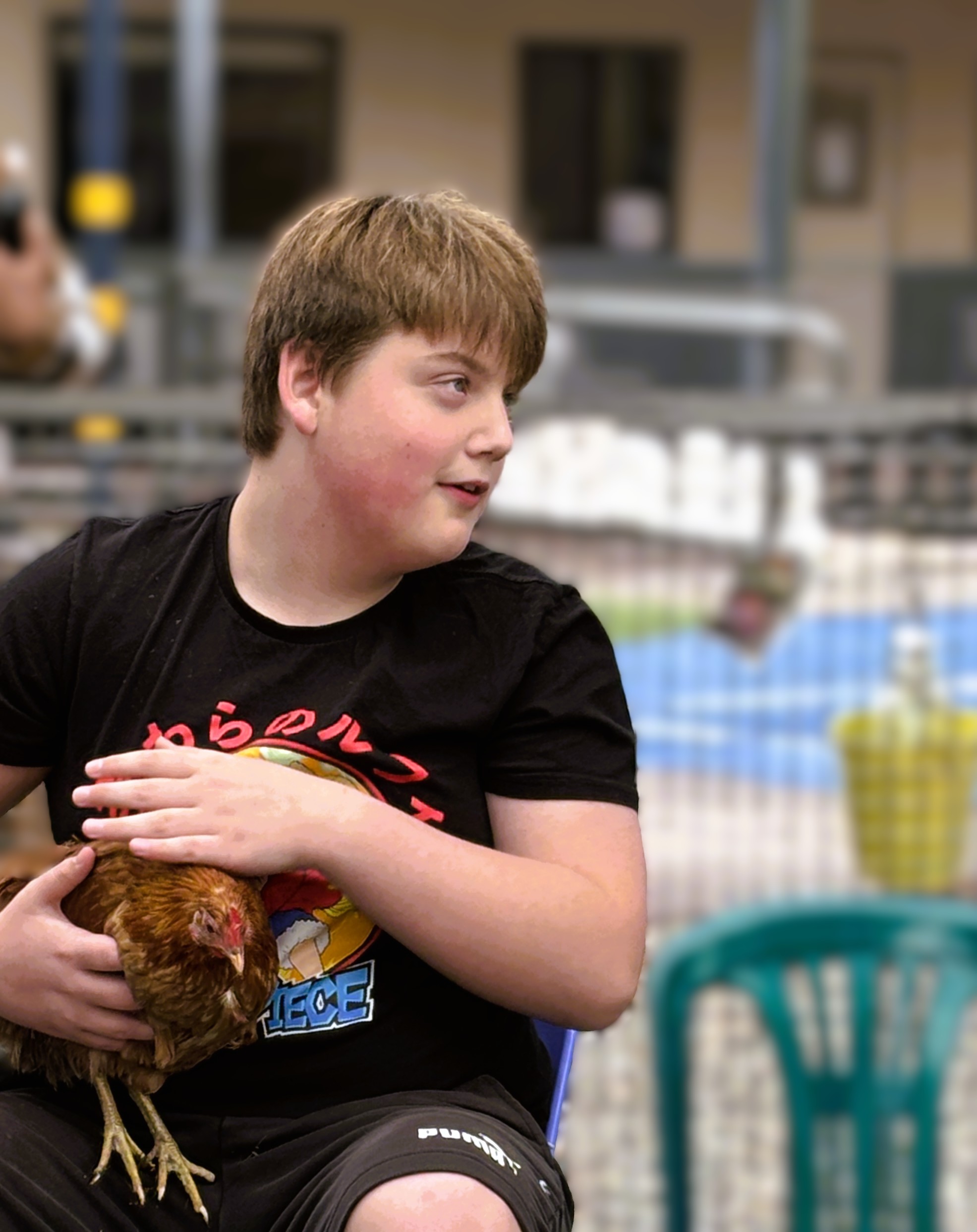 Student holding a chicken at Box Hill Campus